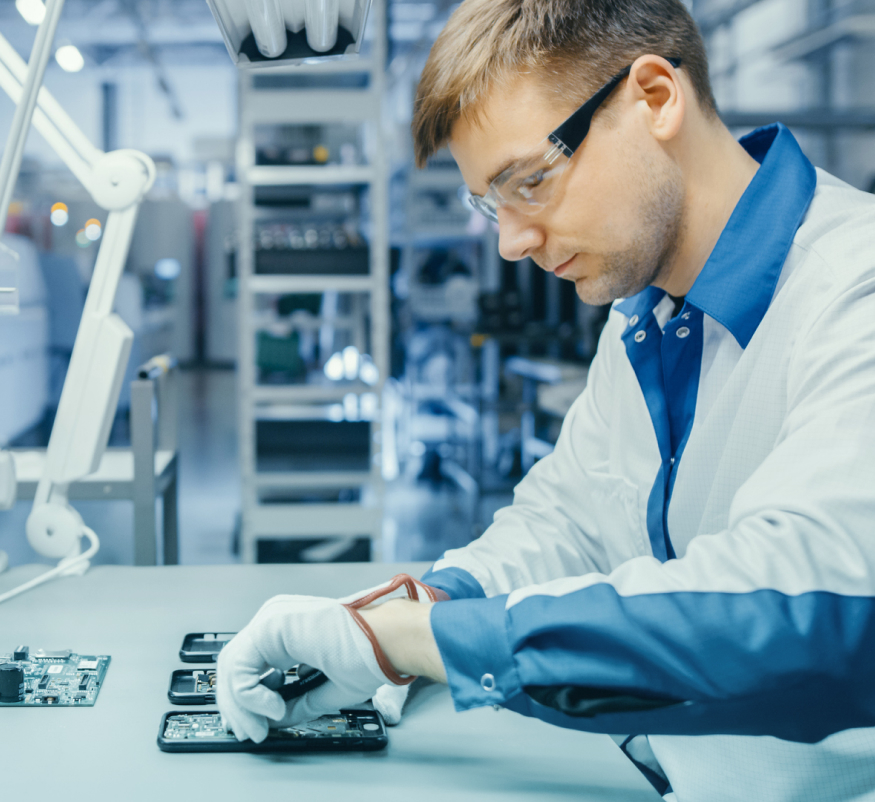 Man working on circuit board in a factory