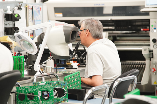 Man working on conventional Assembly of PCBs